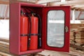 Fire extinguishers on blurry stack of wood in warehouse Royalty Free Stock Photo