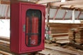 Fire extinguishers on blurry stack of wood in warehouse Royalty Free Stock Photo