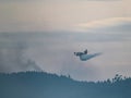 Fire extinguishing plane water bomber dumping its load, Spain Royalty Free Stock Photo