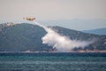 Fire fighter airplane during training throws water on small island. Royalty Free Stock Photo