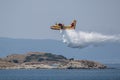 Fire fighter airplane during training throws water on small island. Royalty Free Stock Photo