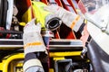 Fire fighters attaching hose at hose laying vehicle Royalty Free Stock Photo