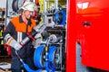 Fire fighter checking hydraulic cutter at fire engine Royalty Free Stock Photo