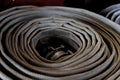 Firehose rolled up at firestation. Royalty Free Stock Photo