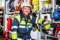 Fire fighter in protective clothes leaning at fire engine Royalty Free Stock Photo