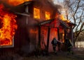 Burning house and fire fighters Royalty Free Stock Photo