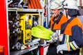 Fire fighters loading hoses into operations vehicle Royalty Free Stock Photo