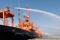 Fire fighting boat sprays water in port.The fire ship is testing the fire fighting equipment in the port