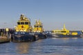 Fire fighting boats of the port of Rotterdam are docked on the side of the maasvlakte near the industrial container port.