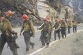 Fire fighting crew carrying equipment