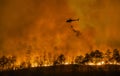 Fire fighting helicopter carry water bucket to extinguish the forest fire