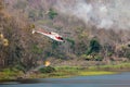 Fire fighting helicopter is carry water for extinguish forest fire Royalty Free Stock Photo