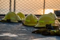 Fire fighting helmets are drying on the navy ship deck after use. Safety net has seen as a background. orange sky between sunset p Royalty Free Stock Photo