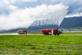 Fire fighting with water spray. Fire truck and fire engine with fire men. Emergency and conflagration. Fire disaster and crisis Royalty Free Stock Photo