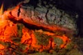 Fire fireplace Embers closeup. Glowing embers in hot red color.