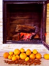 Fire in the fireplace and tangerines and nuts