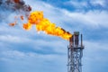 Fire on flare stack at oil and gas central processing platform while burning toxic and release over pressure. Royalty Free Stock Photo