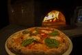 Pizza on wood burning fire oven Royalty Free Stock Photo