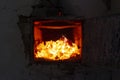 The fire in the furnace. Ember and fire close up. Coals, flames, heat, relax concept background Royalty Free Stock Photo