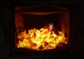 The fire in the furnace. Ember and fire close up. Coals, flames, heat,  relax concept background Royalty Free Stock Photo