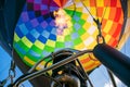 Fire from a gas burner in a hot air balloon. Hot gas inflates a bright, multi-colored balloon. Bottom view