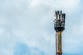 A fire on a GSM antenna on a high tower. On the background of the blue sky, a transmitter for transmitting a 5g signal. danger to