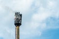 A fire on a GSM antenna on a high tower. On the background of the blue sky, a transmitter for transmitting a 5g signal. danger to Royalty Free Stock Photo