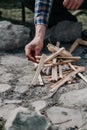 Hand kindles fire between folded chips