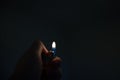 Fire in a hand in a dark room. Sad concept, memory of a man. Lighter with copy space Royalty Free Stock Photo