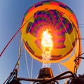 Fire heats the air inside a hot air balloon at balloon festival