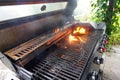 The fire heats up the grate on a gas grill for grilling meat