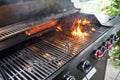 The fire heats up the grate on a gas grill for grilling meat