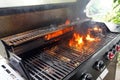 The fire heats up the grate on a gas grill for grilling meat