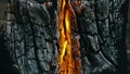 The fire in holes with wood. The bonfire crack chink in Swedish or Finnish log candle. Close up.