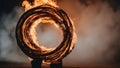 A fire hoop spinning in the darkness, creating a mesmerizing pattern of flames and smoke