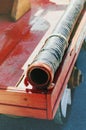 Fire hose on the wooden board of an old red fire truck. Close-up, selective focus. Royalty Free Stock Photo