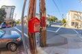 A fire hydrant alarm button in red agains a wooden pole at a cal Royalty Free Stock Photo