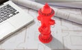 Fire hydrant and laptop on blueprints background. 3d illustration