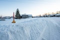 Fire hydrant with a locator protruding from a snow back along a residential street. Royalty Free Stock Photo