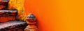 A fire hydrant, positioned near an orange-painted wall, is surrounded by a yellow background Royalty Free Stock Photo