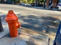 A fire hydrant is spraying water onto the sidewalk Royalty Free Stock Photo