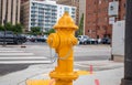 Fire hydrant yellow color in the city center, sunny day