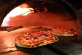 fire inside an oven of Italian pizzeria with pizzas