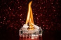 Fire inside square glass ashtray in the dark Royalty Free Stock Photo