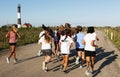 Girls cross country team running on dirt path at Fire Island Lighthouse Royalty Free Stock Photo