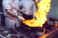 Fire in the kitchen. Fire gas burn is cooking on iron pan,stir fire very hot. Royalty Free Stock Photo