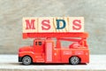 Fire ladder truck hold block in word MSDS Abbreviation of material safety data sheet on wood background Royalty Free Stock Photo