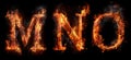 Fire letters MNO font alphabet made of burning letters on black background