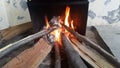 Fire on logs in fire pot with embers and burning coal and blazing flames Royalty Free Stock Photo