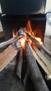 Fire on logs in fire pot with embers and burning coal and blazing flames Royalty Free Stock Photo